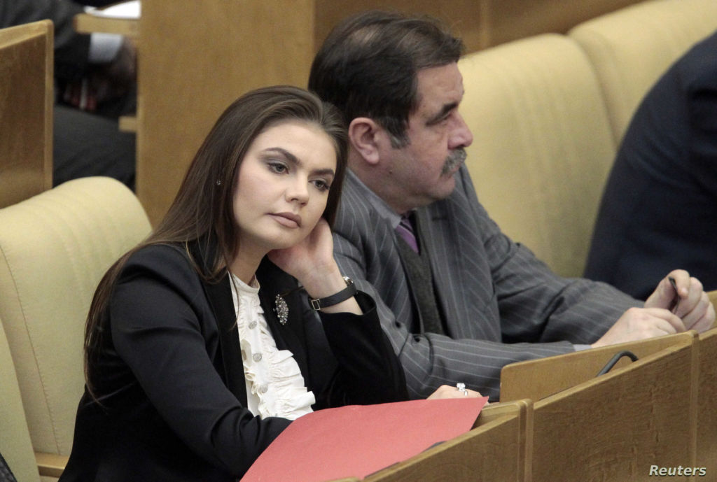 Deputy Chairman of State Duma Committee for Youth Affairs and member of United Russia party Kabaeva listens to Russia's PM Putin speaking at parliament at State Duma in Moscow
