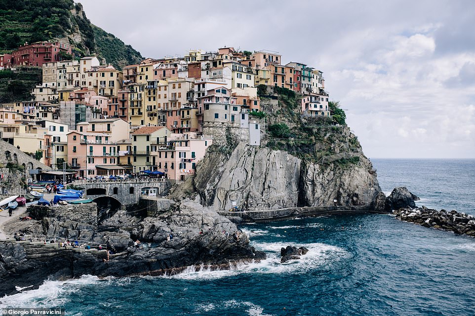 4369572-6185345-The_picturesque_village_of_Manarola_stands_on_the_face_of_a_clif-a-77_1537966479813